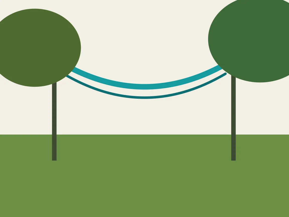 Hammock hung between trees in a shaded tropical garden